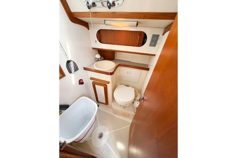 Slide: The Image of 2001 Caliber 40LRC yacht bathroom with wooden accents, sink, and toilet. - 48