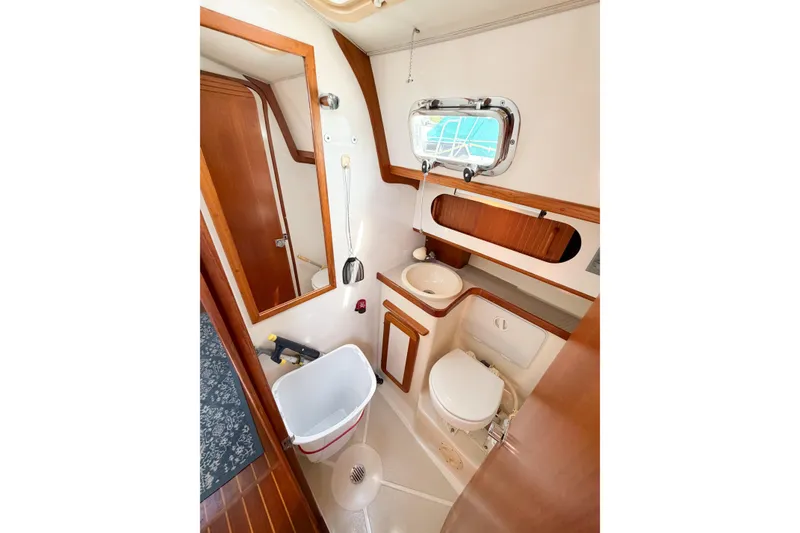 Slide: The Image of 2001 Caliber 40LRC yacht bathroom with wooden accents and compact design. - 49