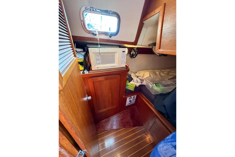 Slide: The Image of Cozy cabin interior of 2001 Caliber 40LRC sailboat with microwave and storage. - 50