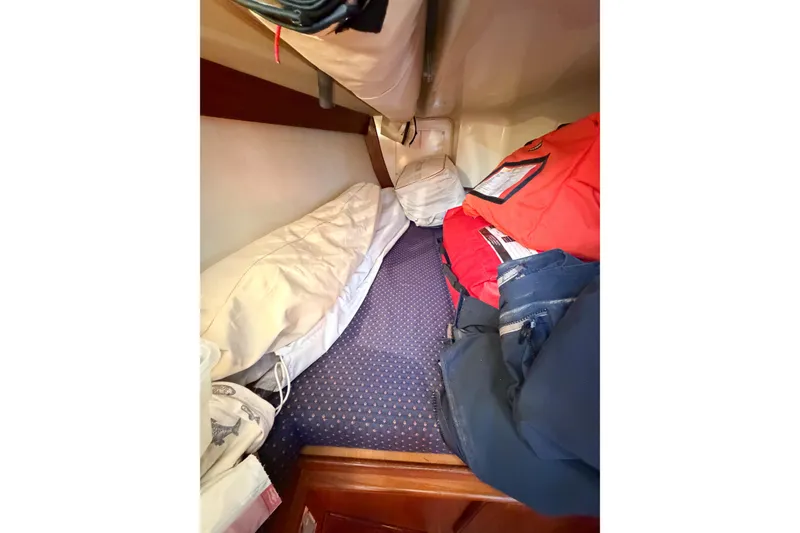 Slide: The Image of Cozy cabin interior of 2001 Caliber 40LRC sailboat with bedding and storage. - 51