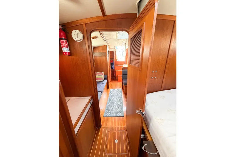 Slide: The Image of Interior view of 2001 Caliber 40LRC sailboat with wooden finish and cozy seating area. - 52