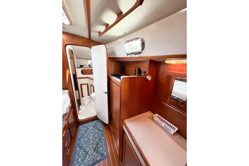 Slide: The Image of Interior of 2001 Caliber 40LRC yacht with wooden cabinetry and compact bathroom. - 54
