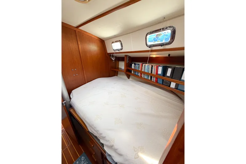 Slide: The Image of Cozy cabin interior of 2001 Caliber 40LRC yacht with bed and bookshelf. - 55