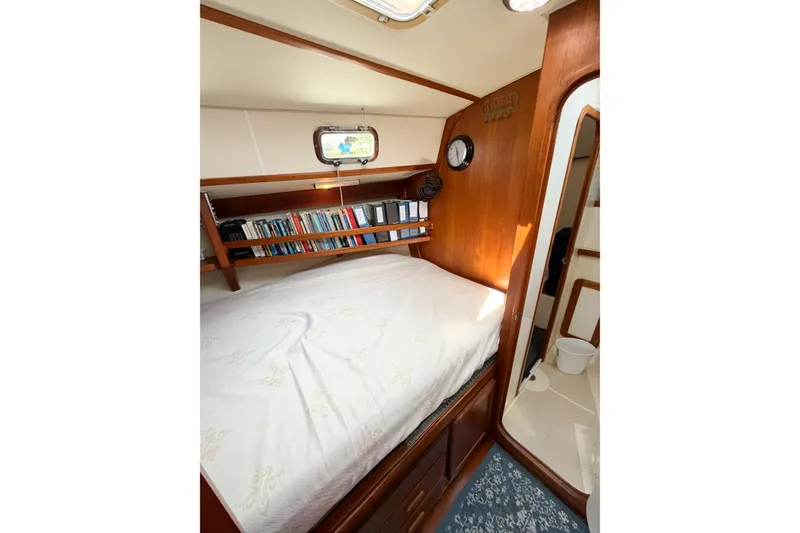 Slide: The Image of Cozy cabin interior of 2001 Caliber 40LRC sailboat with bed and bookshelf. - 56
