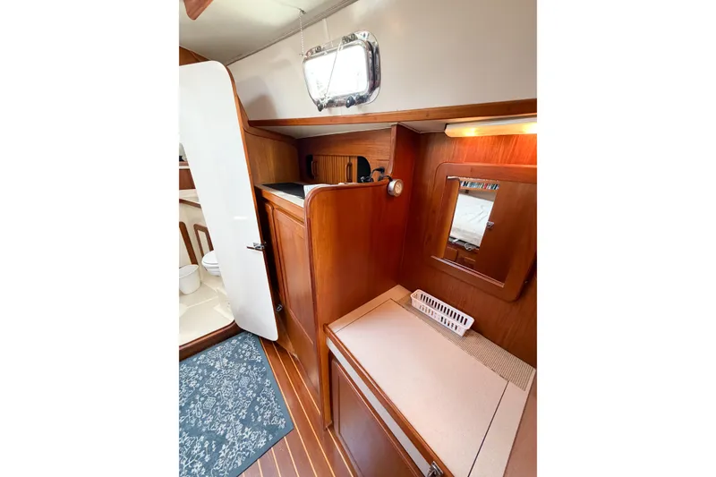 Slide: The Image of Interior of 2001 Caliber 40LRC sailboat with wooden cabinetry and nautical decor. - 57