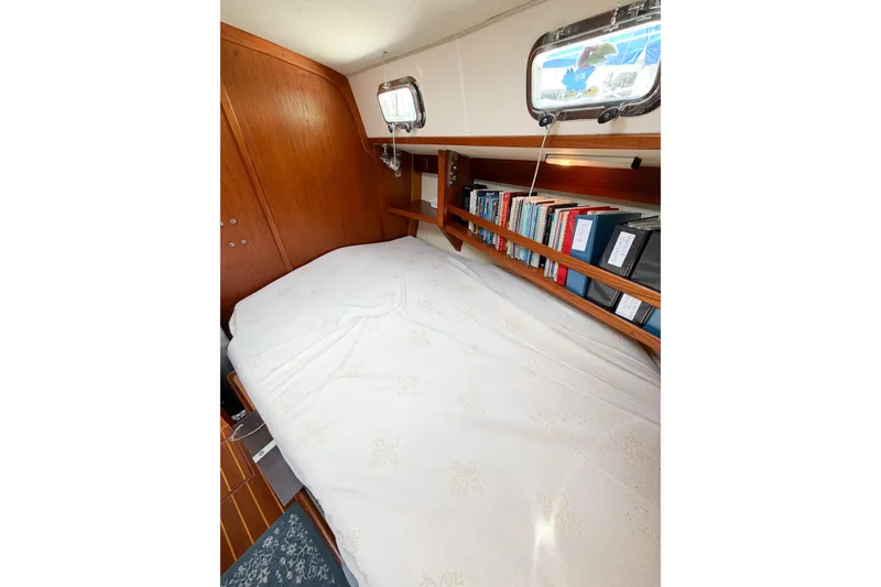 Slide: The Image of Cozy cabin interior of 2001 Caliber 40LRC sailboat with bed and bookshelf. - 58
