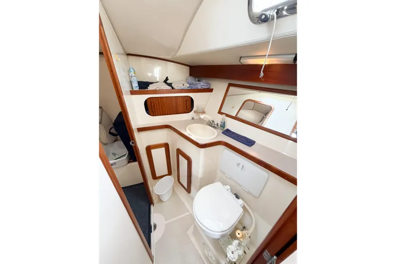 Slide: The Image of 2001 Caliber 40LRC yacht bathroom with sink, toilet, mirror, and wooden accents. - 59