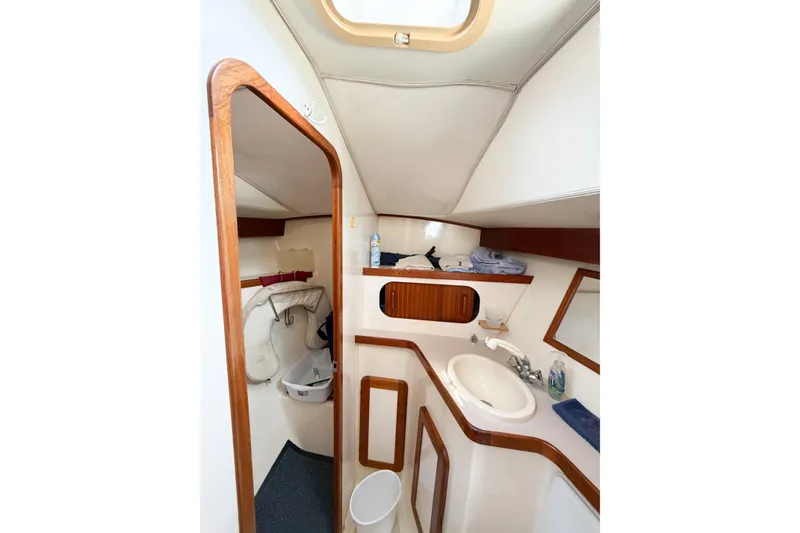 Slide: The Image of Interior of 2001 Caliber 40LRC yacht bathroom with sink and storage. - 60