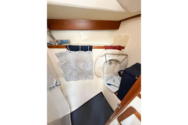 Slide: The Image of Interior of 2001 Caliber 40LRC sailboat with storage and hanging organizer. - 61