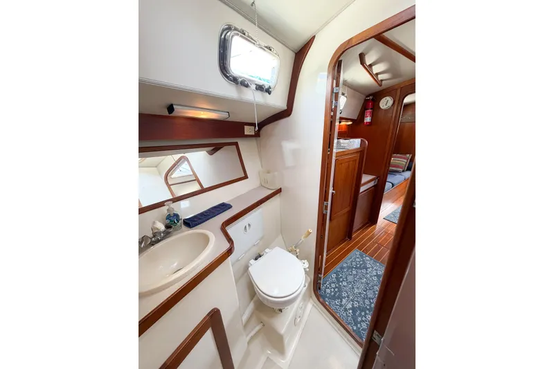 Slide: The Image of 2001 Caliber 40LRC yacht bathroom with sink, toilet, and wooden accents. - 62