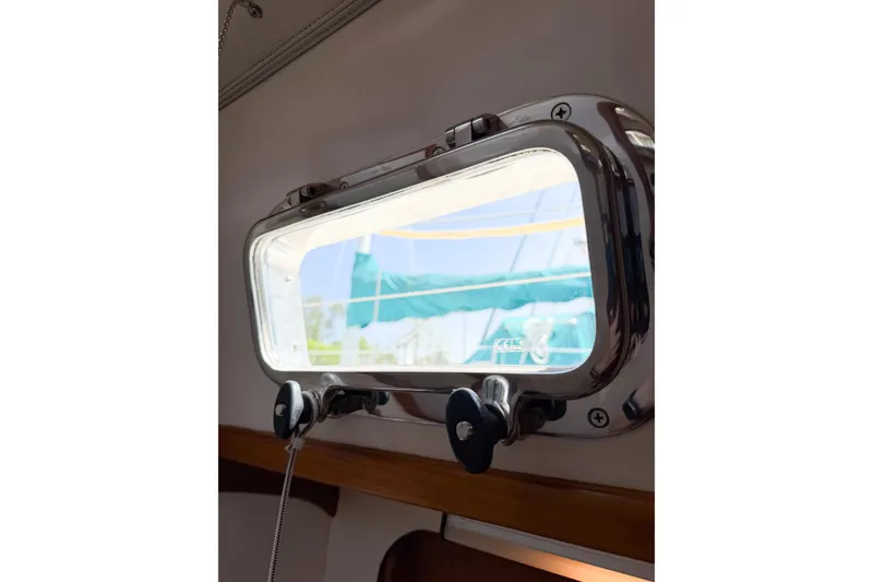 Slide: The Image of Porthole view from 2001 Caliber 40LRC sailboat, showcasing exterior with blue and green hues. - 63