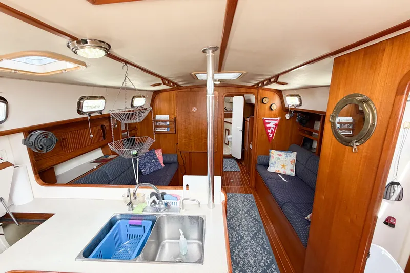 Slide: The Image of Interior of 2001 Caliber 40LRC sailboat with wooden finishes and cozy seating area. - 64