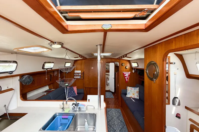 Slide: The Image of Interior of 2001 Caliber 40LRC sailboat featuring cozy seating and wooden finishes. - 65