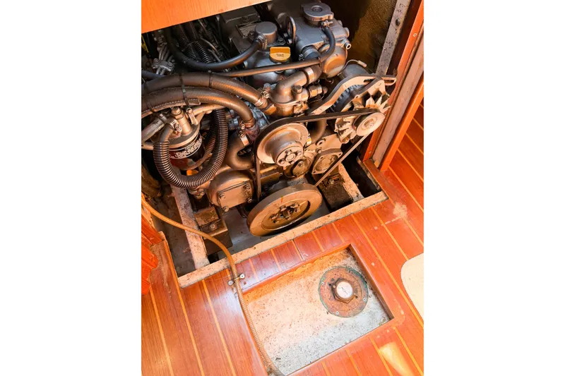 Slide: The Image of Engine compartment of a 2001 Caliber 40LRC sailboat, showcasing mechanical components and wooden flooring. - 67