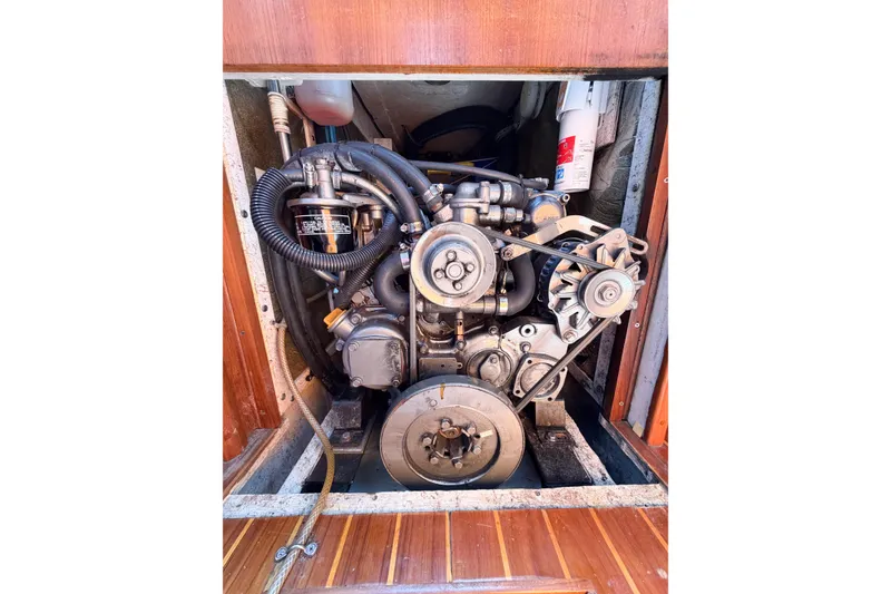 Slide: The Image of Engine compartment of a 2001 Caliber 40LRC sailboat, showcasing mechanical components and belts. - 69