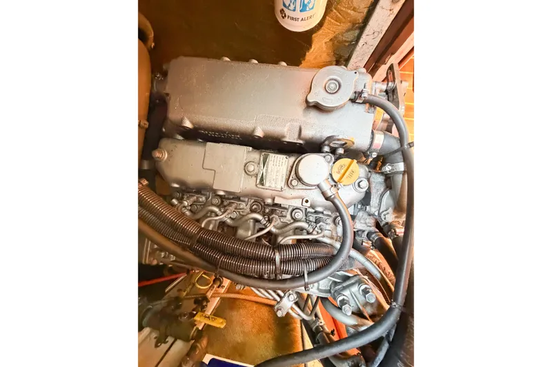 Slide: The Image of 2001 Caliber 40LRC engine with visible hoses and components in a mechanical setting. - 70