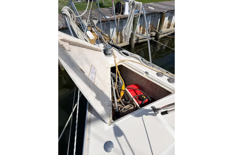 Slide: The Image of Open storage compartment on 2001 Caliber 40LRC sailboat, docked with visible ropes and equipment. - 72