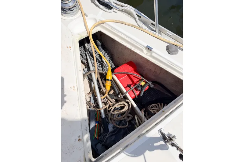 Slide: The Image of Open storage compartment on 2001 Caliber 40LRC boat with ropes and equipment. - 73