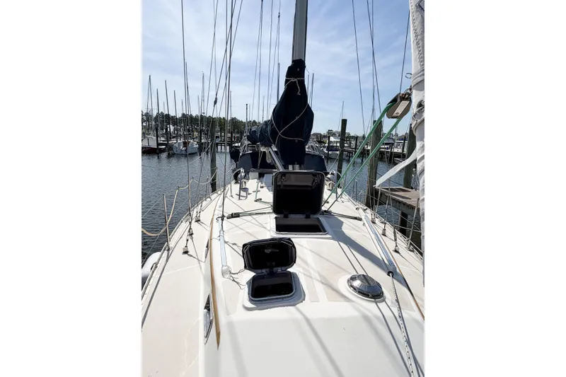 Slide: The Image of 2001 Caliber 40LRC sailboat deck view at marina, showcasing open hatches and rigging. - 75