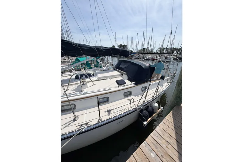Slide: The Image of 2001 Caliber 40LRC sailboat docked at marina, surrounded by other boats. - 9