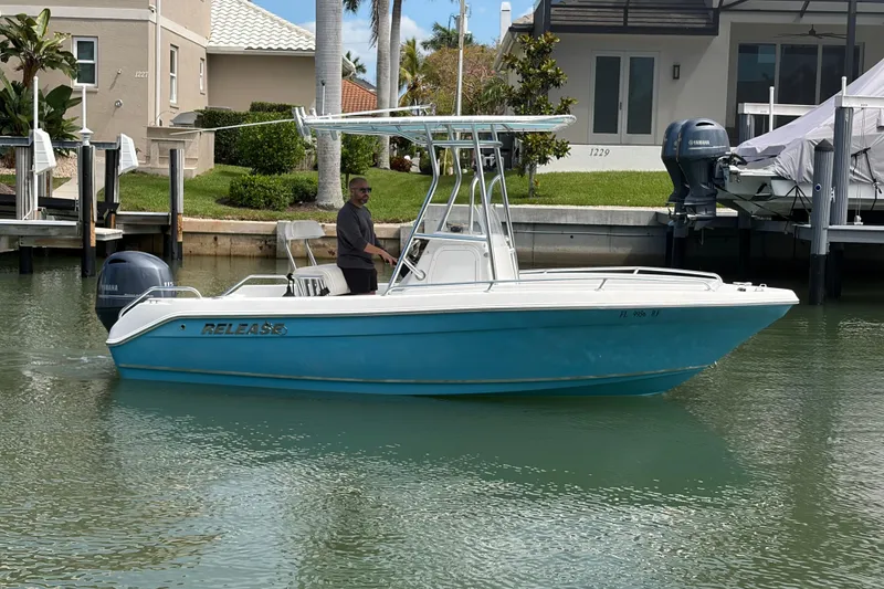 The Image of 2017 Release 196 RX boat on water near dock, featuring blue hull and Yamaha engine. - 1