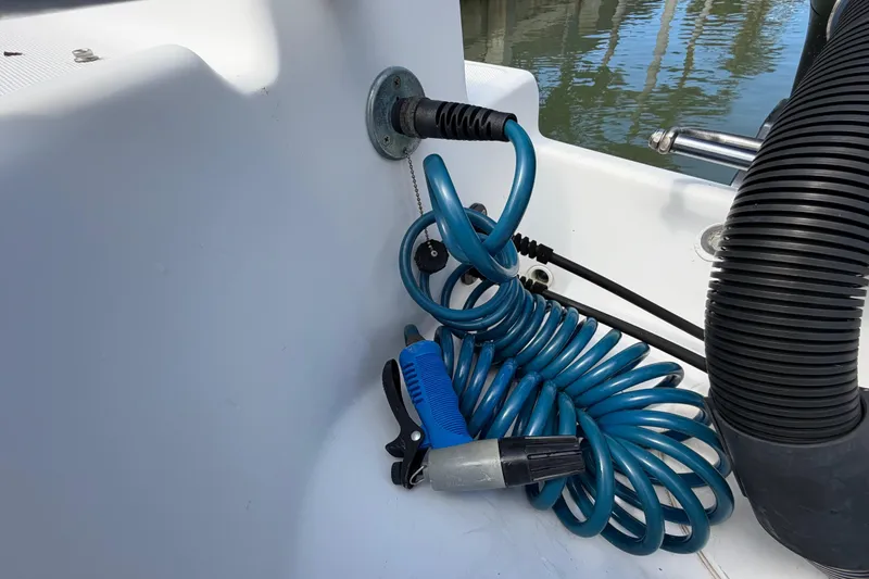 Slide: The Image of Coiled blue hose and nozzle on 2017 Release 196 RX boat deck. - 16