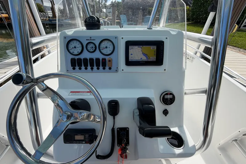 Slide: The Image of Steering console of a 2017 Release 196 RX boat with navigation and control instruments. - 21