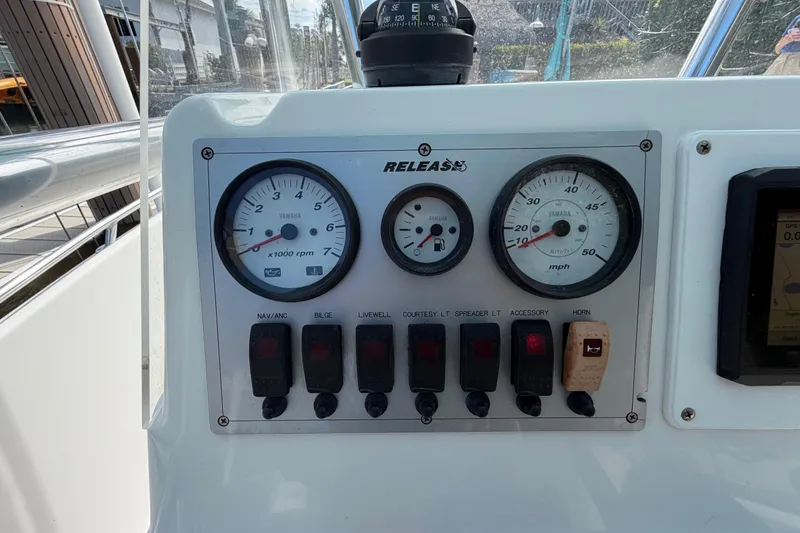 Slide: The Image of Control panel of a 2017 Release 196 RX boat with gauges and switches. - 23