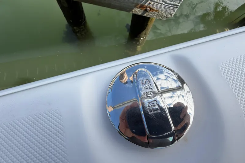 Slide: The Image of Chrome gas cap on 2017 Release 196 RX boat, reflecting sky and water. - 27