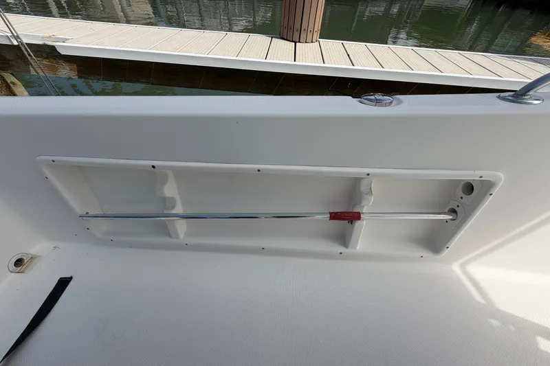 Slide: The Image of Interior view of a 2017 Release 196 RX boat with rod holder and dock background. - 31