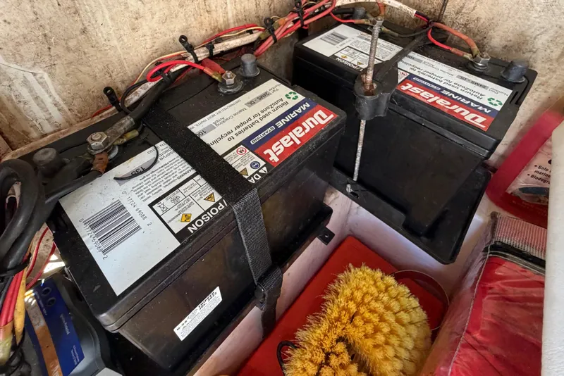 Slide: The Image of Two Duralast marine batteries with cables, inside a compartment of a 2017 Release 196 RX. - 36