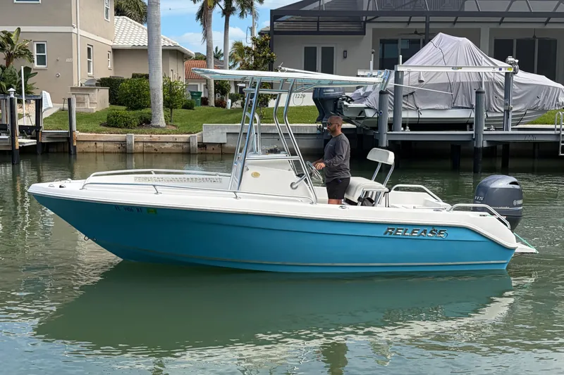 Slide: The Image of A 2017 Release 196 RX boat in a residential canal setting. - 4