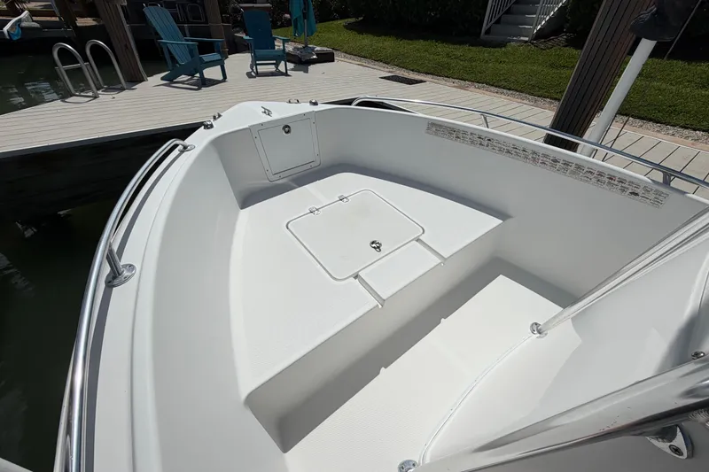 Slide: The Image of Bow area of a 2017 Release 196 RX boat docked near wooden deck. - 40