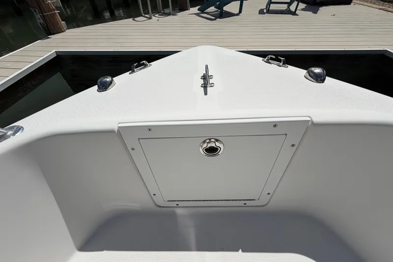 Slide: The Image of Bow of a 2017 Release 196 RX boat docked at a wooden pier. - 44