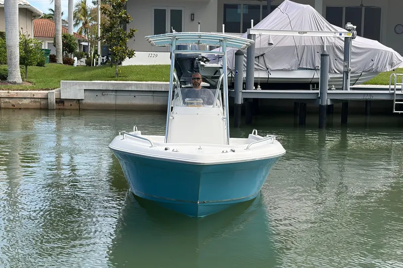 Slide: The Image of 2017 Release 196 RX boat on calm water near docked boats and waterfront homes. - 5