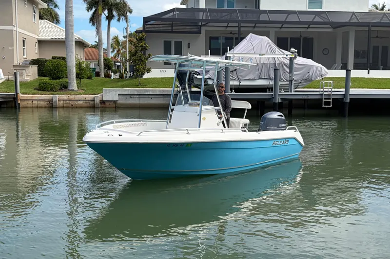 Slide: The Image of 2017 Release 196 RX boat on calm water near waterfront homes. - 6