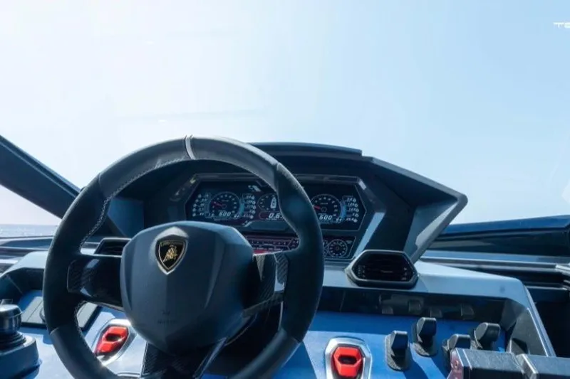 Slide: The Image of Steering wheel and dashboard of 2026 Tecnomar LY63 yacht, featuring luxury design elements. - 2