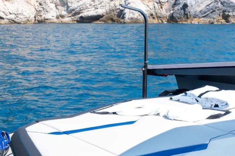 Slide: The Image of Luxury Tecnomar LY63 yacht on blue sea, rocky coastline in background, 2026 model. - 7