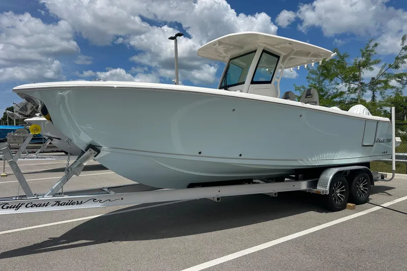 The Image of 2026 Sailfish 272 CC boat on trailer under blue sky. - 0