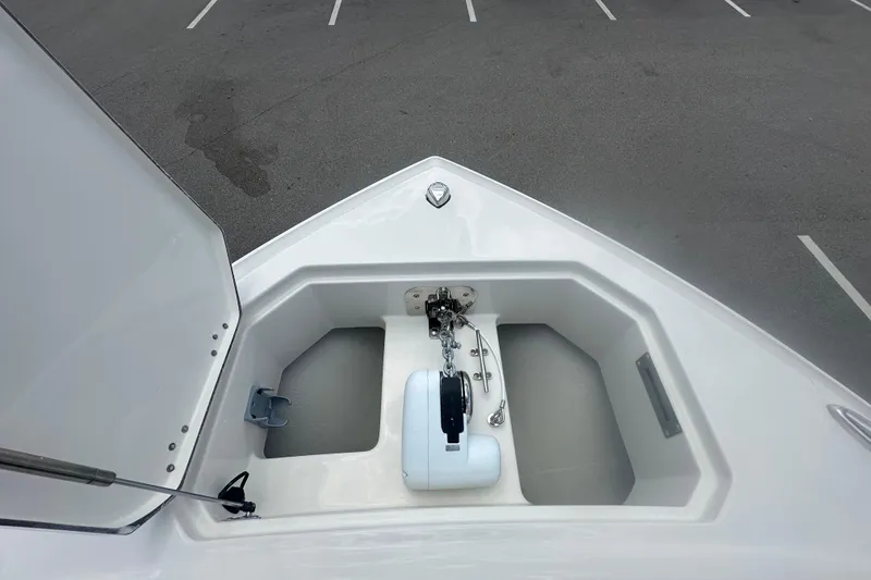 Slide: The Image of Bow anchor compartment of 2026 Sailfish 272 CC boat in a parking lot. - 13