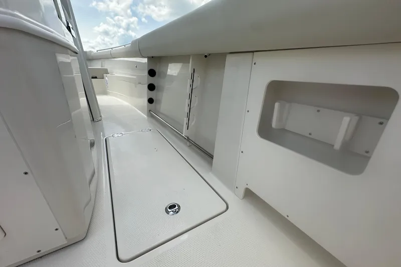 Slide: The Image of 2026 Sailfish 272 CC boat interior with sleek white deck and storage compartments. - 16