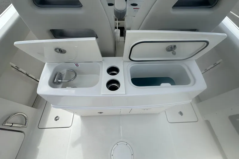 Slide: The Image of 2026 Sailfish 272 CC boat interior with sink and storage compartments. - 23