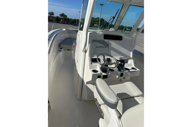 Slide: The Image of 2026 Sailfish 272 CC boat interior with Garmin navigation system and steering wheel. - 29
