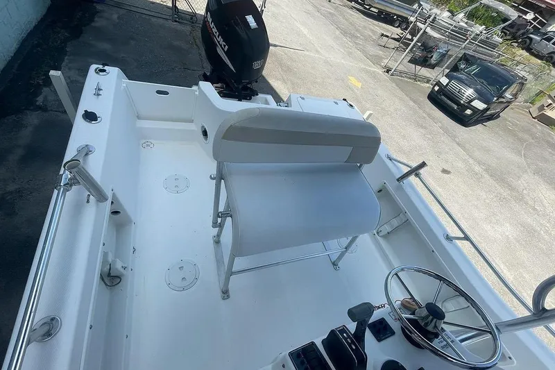 Slide: The Image of 2007 ProKat CS200 boat interior with steering wheel and seating, featuring Suzuki outboard motor. - 5