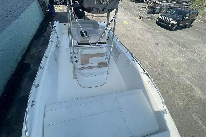 Slide: The Image of 2007 ProKat CS200 boat with spacious deck and seating, parked outdoors. - 8