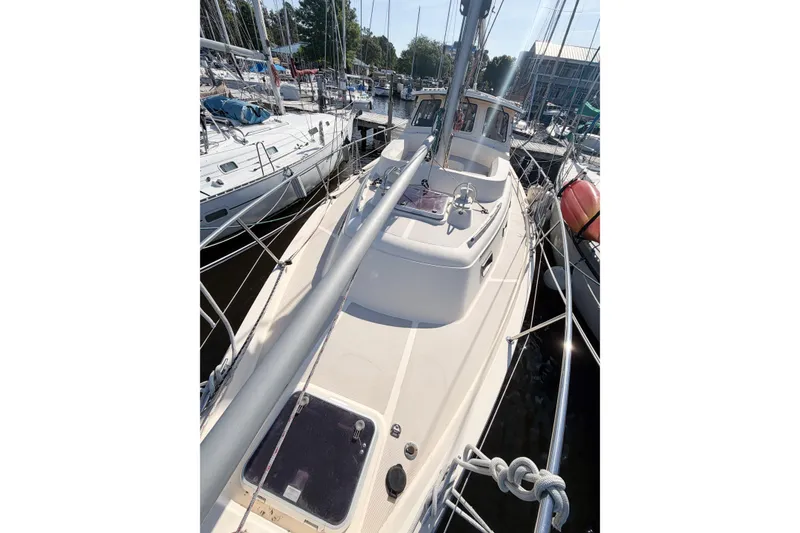 Slide: The Image of 2007 Island Packet SP Cruiser sailboat docked at marina, view of deck and mast. - 11