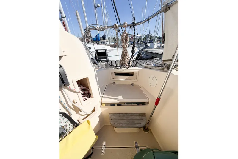 Slide: The Image of 2007 Island Packet SP Cruiser cockpit with ropes and seating, docked at marina. - 13