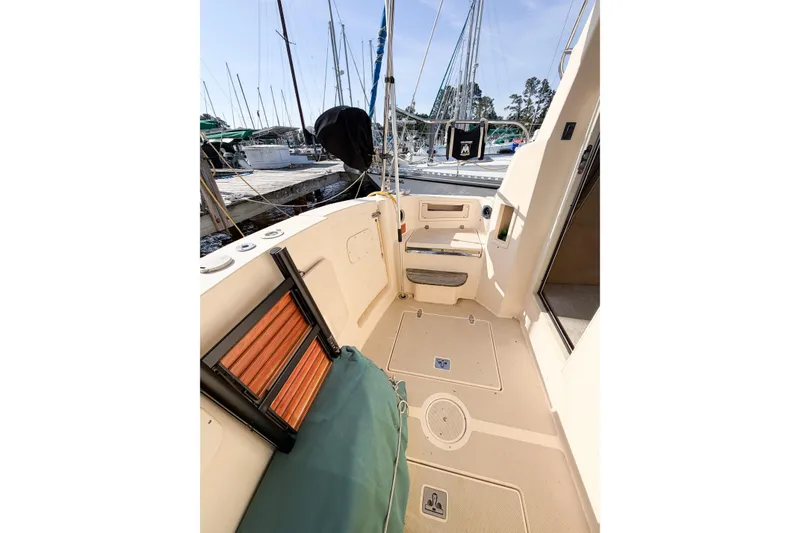 Slide: The Image of 2007 Island Packet SP Cruiser deck with seating, docked at marina. - 14