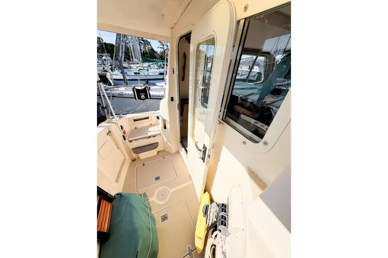 Slide: The Image of 2007 Island Packet SP Cruiser cockpit with seating and marina view. - 16