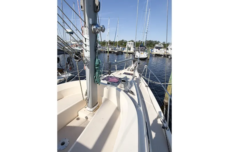 Slide: The Image of 2007 Island Packet SP Cruiser sailboat deck view at marina, showcasing mast and rigging. - 18